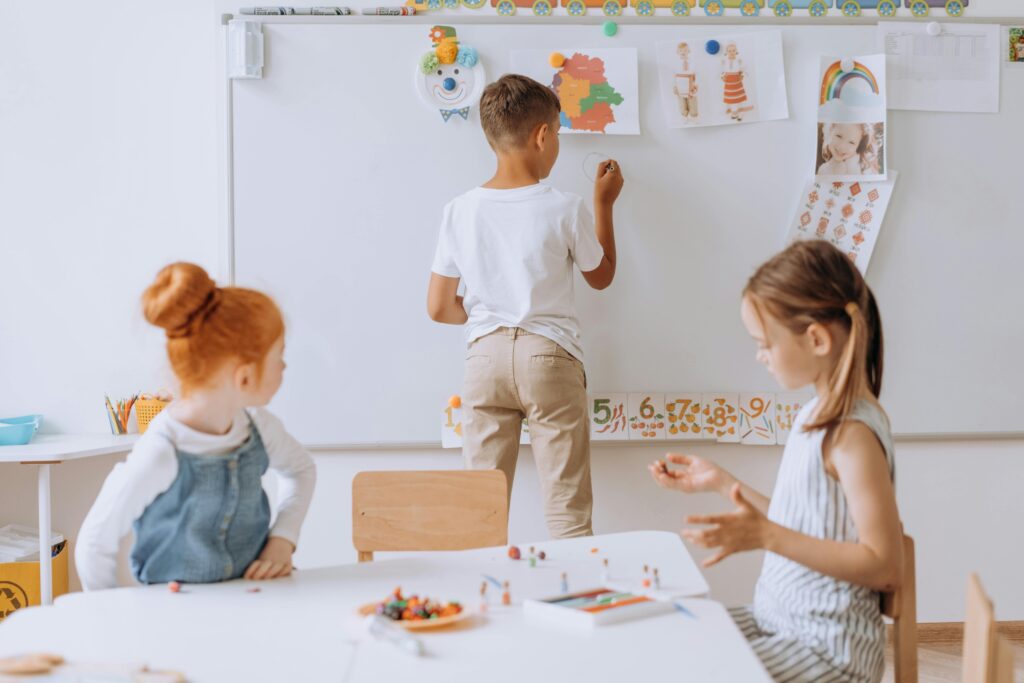 Young children engaging in creative activities in a vibrant classroom.